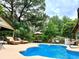 Beautiful pool surrounded by lush landscaping and comfortable seating, ideal for outdoor relaxation and enjoyment at 5521 Sw 31St St, Ocala, FL 34474