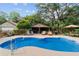 Beautiful pool area featuring a bar, lounge chairs, and outdoor seating, perfect for relaxation and entertaining at 5521 Sw 31St St, Ocala, FL 34474