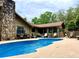 Beautiful pool area with stone fireplace, perfect for relaxing and entertaining guests in a tropical environment at 5521 Sw 31St St, Ocala, FL 34474