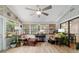 Cozy sun room with lots of windows, comfortable furniture, plants, and a view to the outside at 5521 Sw 31St St, Ocala, FL 34474
