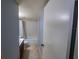 Hallway view into a bathroom featuring a vanity, toilet, and a bathtub with shower at 559 Fairway Circle # A, Ocala, FL 34472