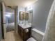 Bathroom featuring a toilet, a vanity and mirrors in the background at 559 Fairway Circle # A, Ocala, FL 34472