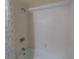 Clean, bright bathtub with a shower featuring white tiling and botanical shower curtain at 559 Fairway Circle # A, Ocala, FL 34472