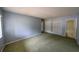 Bright bedroom featuring green carpet, blue walls, and closet space at 559 Fairway Circle # A, Ocala, FL 34472