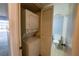 Closet housing stacked washer and dryer, with a view into the bathroom at 559 Fairway Circle # A, Ocala, FL 34472