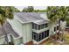 Corner-view of the two-story condo shows the screened in porch and well-maintained gray roof at 559 Fairway Circle # A, Ocala, FL 34472