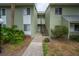 The condo's exterior is landscaped with greenery, complemented by a sidewalk leading to the entrance at 559 Fairway Circle # A, Ocala, FL 34472