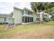 Exterior view of a two-story building with screened lanai and landscaping at 559 Fairway Circle # A, Ocala, FL 34472