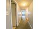 Hallway with neutral walls, plush carpet, and convenient access to various rooms in the home at 559 Fairway Circle # A, Ocala, FL 34472