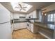 Charming kitchen with a skylight, white appliances, and lots of counter space perfect for cooking at 559 Fairway Circle # A, Ocala, FL 34472