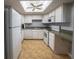 A well-lit kitchen with a skylight, white appliances, and ample cabinet space at 559 Fairway Circle # A, Ocala, FL 34472