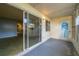 Covered lanai with sliding glass door to living room and a door to the yard at 559 Fairway Circle # A, Ocala, FL 34472