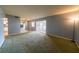 Spacious living room with carpet, sliding glass doors to a screened patio, and mirrored wall at 559 Fairway Circle # A, Ocala, FL 34472