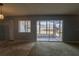 A spacious living room featuring a sliding glass door to a screened lanai at 559 Fairway Circle # A, Ocala, FL 34472