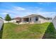 A spacious backyard featuring a well-manicured lawn, patio, outdoor dining, and lounge seating at 5862 Sw 80Th Ln, Ocala, FL 34476