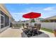 Backyard patio featuring an outdoor dining set, lounge chairs, and a grill perfect for entertaining at 5862 Sw 80Th Ln, Ocala, FL 34476
