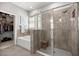 Modern bathroom featuring a glass-enclosed shower, a separate soaking tub, and a walk-in closet at 5862 Sw 80Th Ln, Ocala, FL 34476