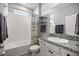 Well-lit bathroom featuring a shower-tub combo with decorative shower curtain and granite countertop vanity at 5862 Sw 80Th Ln, Ocala, FL 34476