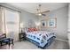 Cozy bedroom boasts a ceiling fan, a bright window, and tastefully coordinated decor, offering a relaxing retreat at 5862 Sw 80Th Ln, Ocala, FL 34476