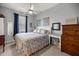 Comfortable bedroom with floral bedding, ceiling fan, and dresser at 5862 Sw 80Th Ln, Ocala, FL 34476
