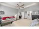 Spacious bedroom with a tray ceiling, fan, and an adjacent sitting area, offering a relaxing retreat at 5862 Sw 80Th Ln, Ocala, FL 34476