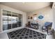 Enclosed lanai featuring an outdoor seating area, rug, wall art, and sliding glass doors at 5862 Sw 80Th Ln, Ocala, FL 34476