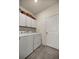 Clean laundry room with white cabinets and tiled floor at 5862 Sw 80Th Ln, Ocala, FL 34476