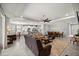 Open-concept living space with a modern kitchen featuring white cabinets and stainless steel appliances at 5862 Sw 80Th Ln, Ocala, FL 34476