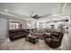 Expansive living room with a tray ceiling, a ceiling fan, and an open layout to the kitchen at 5862 Sw 80Th Ln, Ocala, FL 34476