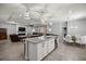 Open concept living space with kitchen island, dining area, and comfortable seating at 5862 Sw 80Th Ln, Ocala, FL 34476