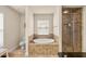 Bright bathroom showcasing a separate shower and soaking tub at 6436 Sw 44Th Ct, Ocala, FL 34474