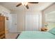Comfortable bedroom featuring a ceiling fan and double door closet at 6436 Sw 44Th Ct, Ocala, FL 34474