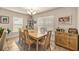 Cozy dining area featuring a wooden table and sunlit windows at 6436 Sw 44Th Ct, Ocala, FL 34474