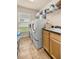 Laundry room with front loading washer and dryer, shelving and cabinet at 6436 Sw 44Th Ct, Ocala, FL 34474