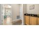 Charming laundry room with a window, folding table, and cabinet at 6436 Sw 44Th Ct, Ocala, FL 34474