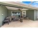 Covered patio area with comfortable seating and view of backyard at 6436 Sw 44Th Ct, Ocala, FL 34474