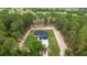 Aerial view of the home, showcasing the roof and surrounding wooded landscape at 7483 Sw 121St Ter, Dunnellon, FL 34432
