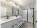 Bathroom featuring double sinks, quartz counters, and glass-enclosed shower at 7483 Sw 121St Ter, Dunnellon, FL 34432