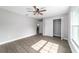 Spacious bedroom boasts wood-look floors, modern ceiling fan, closet, and ample natural light from the window at 7483 Sw 121St Ter, Dunnellon, FL 34432