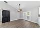 Dining room with a modern chandelier and wood-look flooring next to sliding black barn door at 7483 Sw 121St Ter, Dunnellon, FL 34432
