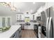 Well-appointed kitchen with stainless steel appliances, a gray backsplash, and a large island at 7483 Sw 121St Ter, Dunnellon, FL 34432