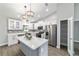 Bright, modern kitchen featuring white cabinets, stainless steel appliances, and a center island at 7483 Sw 121St Ter, Dunnellon, FL 34432