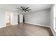 Large main bedroom with ceiling fan, wood-look floors, and ensuite bathroom at 7483 Sw 121St Ter, Dunnellon, FL 34432