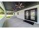 Expansive covered patio with black-painted wood ceiling, ceiling fans, and views of the lush, private backyard at 7483 Sw 121St Ter, Dunnellon, FL 34432