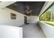 Large covered patio featuring modern ceiling fans, a black-painted wood ceiling, and a spacious outdoor area at 7483 Sw 121St Ter, Dunnellon, FL 34432