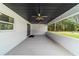 Covered patio featuring dual ceiling fans and ample space for outdoor living at 7483 Sw 121St Ter, Dunnellon, FL 34432