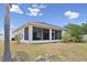 View of the screened-in lanai extending across the back exterior, offering a comfortable and bug-free outdoor space at 808 Overlook Grove Dr, Winter Haven, FL 33884