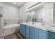 Bright bathroom featuring double sinks, a soaking tub, and modern fixtures at 808 Overlook Grove Dr, Winter Haven, FL 33884