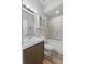 Bathroom featuring a combination tub and shower, wood vanity, and modern lighting at 808 Overlook Grove Dr, Winter Haven, FL 33884