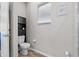 Efficient bathroom with a toilet, storage cabinet, and a window for natural light at 808 Overlook Grove Dr, Winter Haven, FL 33884